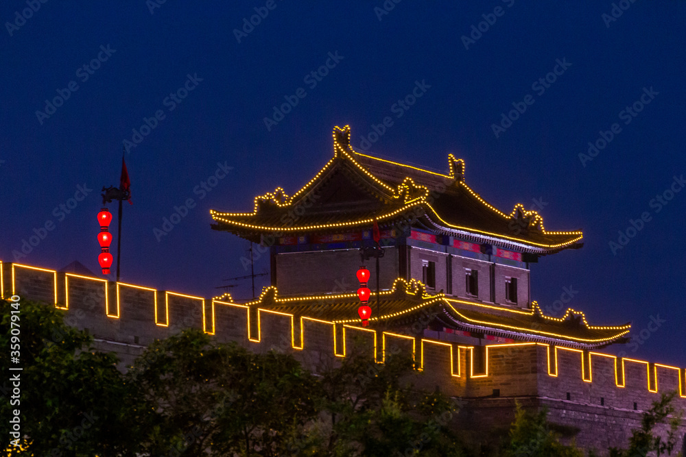 Fototapeta premium Evening view of illuminated city walls in Xi'an, China