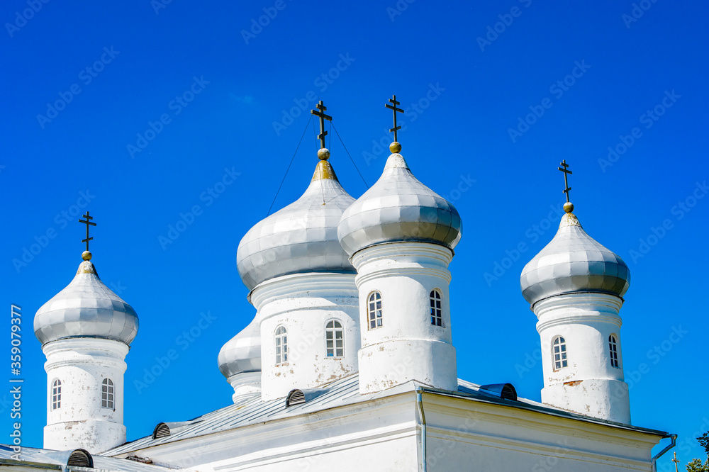 It's St. George's (Yuriev) Monastery, Russia's oldest monastery. It is part of the World Heritage Site named Historic Monuments of Novgorod and Surroundings.