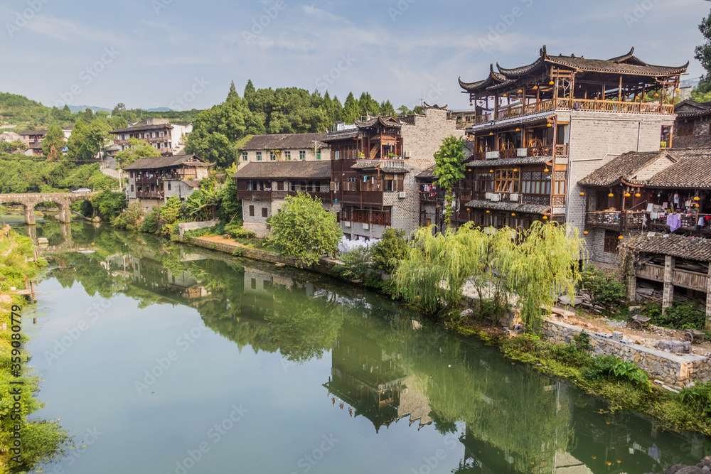 Traditional houses reflecting in a river in Furong Zhen town, Hunan province, China