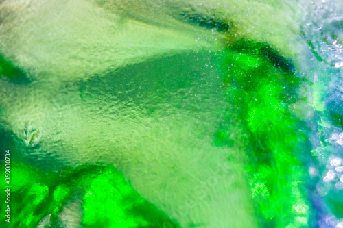 A green colored glass from a bottle sifting the light