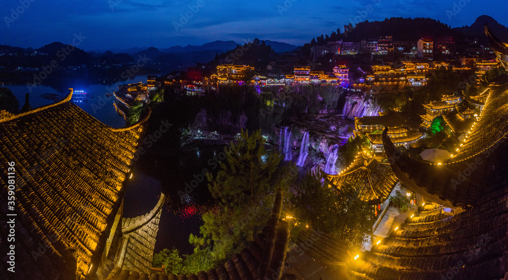 Fototapeta premium Evening view of Furong Zhen town and waterfall, Hunan province, China