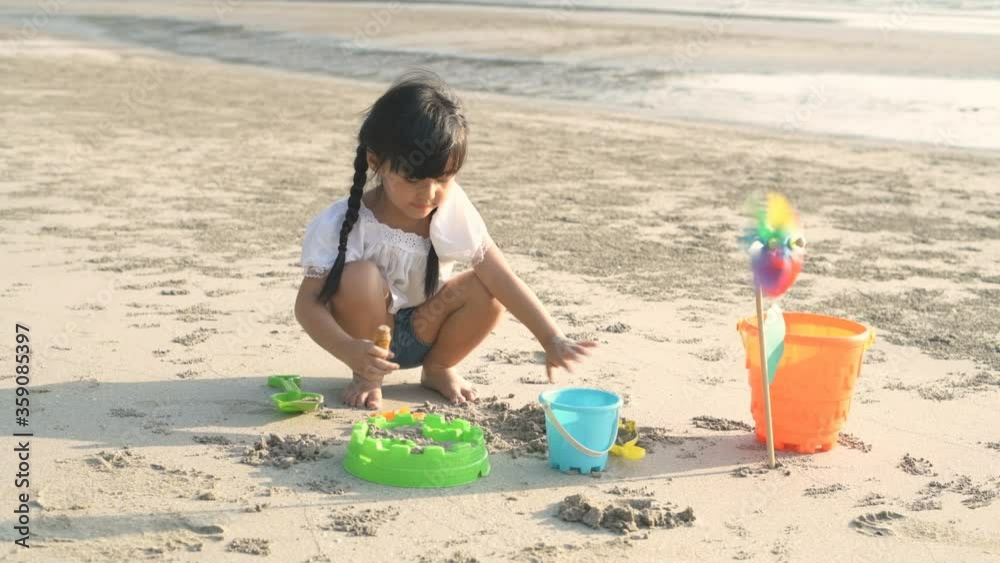 Family concept. Children making sand playing on the beach. 4k Resolution. Family concept. Children making sand playing on the beach. 4k Resolution.