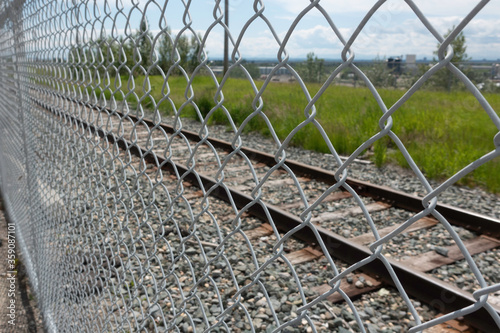 Chain Link Mesh Fence in front of Railway Track