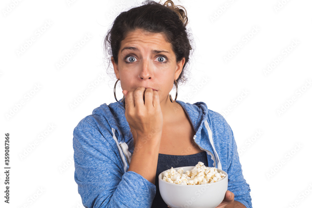 woman watching a movie while eating popcorn. woman watching a movie while eating popcorn.