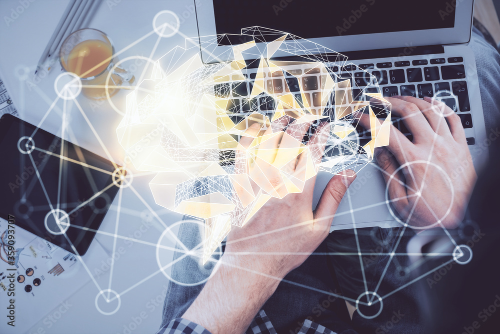 Double exposure of man's hands typing over computer keyboard and brain hologram drawing. Top view. Ai and data technology concept. Double exposure of man's hands typing over computer keyboard and brain hologram drawing. Top view. Ai and data technology concept.