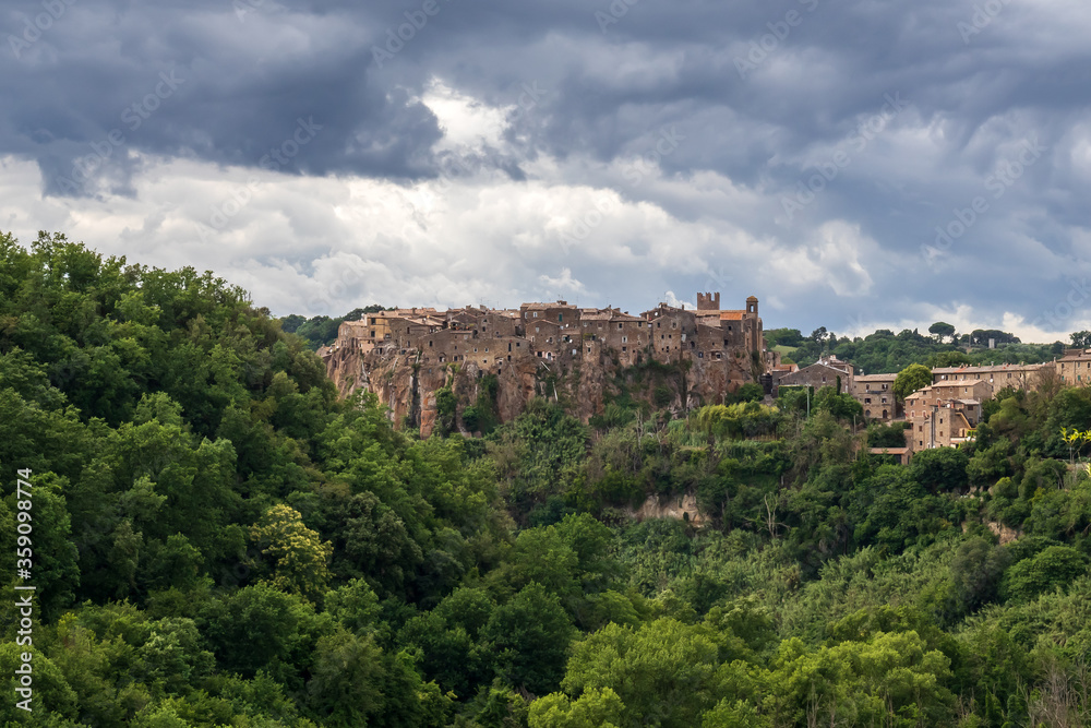 Calcata, small medieval village, Italy. Panoramic view of the village of Calcata, in the province of Viterbo, Italy. Medieval village built entirely of tuff and immersed in the green of the forest.