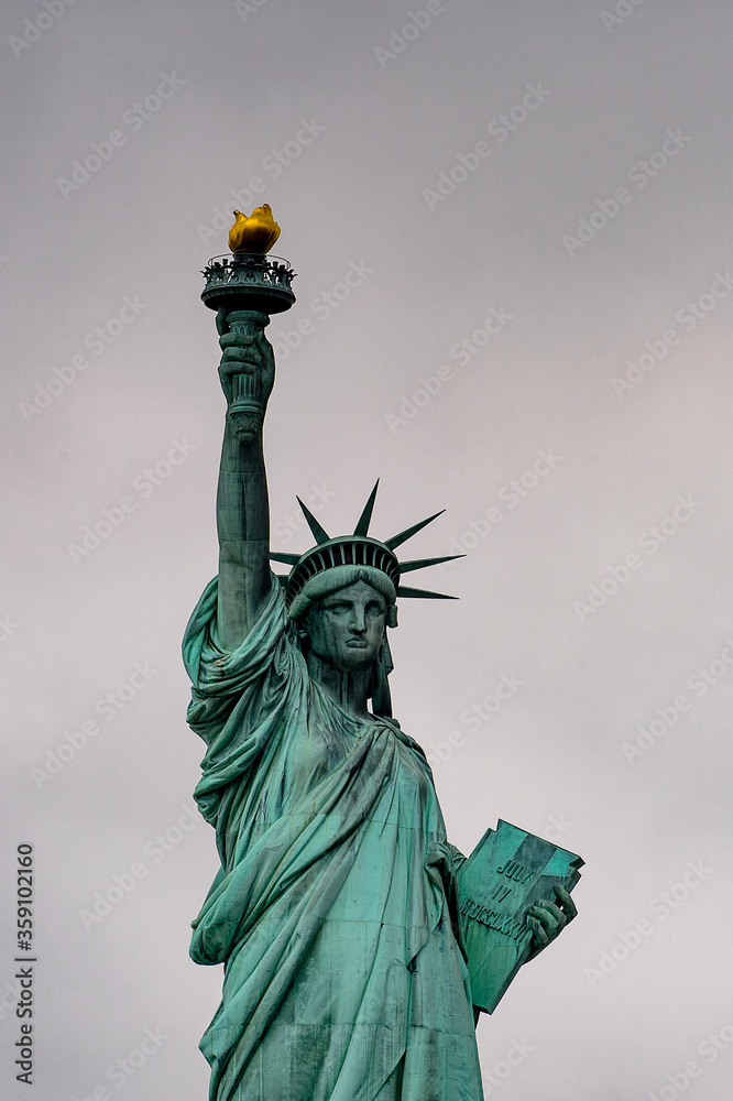 Fototapeta premium Statue of Liberty of New York on a cloudy day, NY, United Sates of America