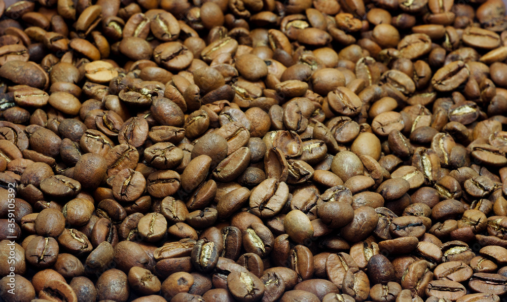 Dark roasted coffee beans background, top view Dark roasted coffee beans background, top view