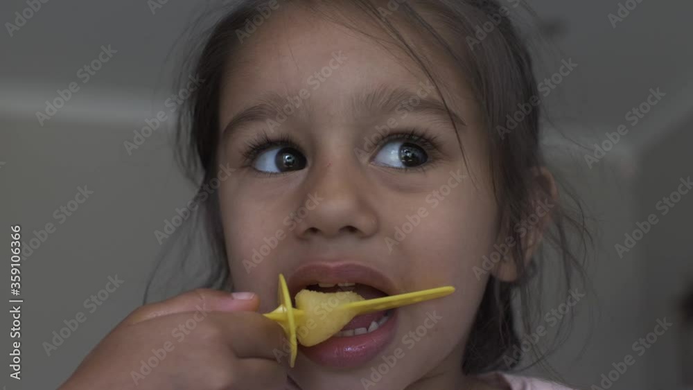 Four Year Old UK Asian Child Eating Ice Lolly. Low Angle, Locked Off Four Year Old UK Asian Child Eating Ice Lolly. Low Angle, Locked Off