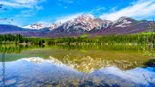Reflection of Pyramid Mountain in Pyramid Lake in Jasper National Park in Alberta, Canada. The mountains is part of the Victoria Cross Range in the Rocky Mountains