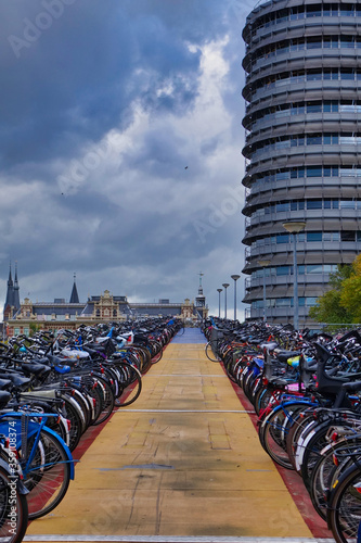 a bicycle parking lot between tall buildings