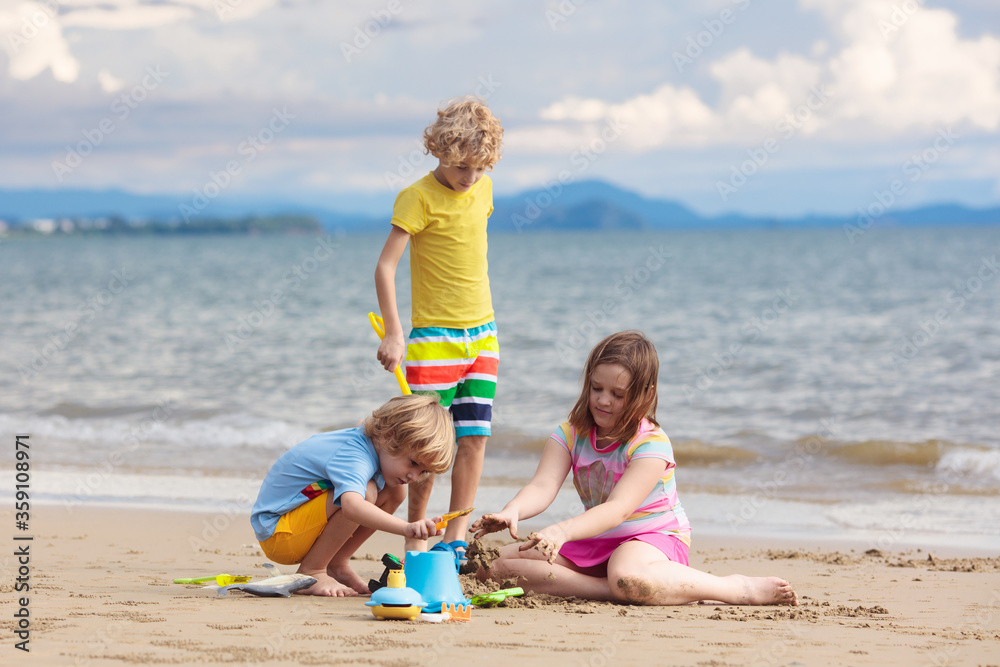 Kids play on tropical beach. Sand and water toy. Kids play on tropical beach. Sand and water toy.