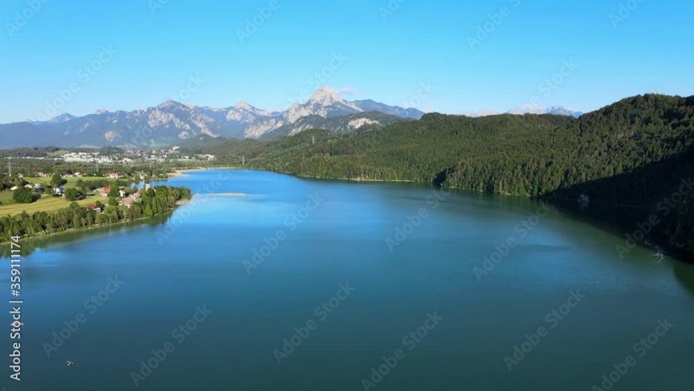 Lake Weissensee in Bavaria - beautiful small lake in the Allgau district - aerial drone footage Lake Weissensee in Bavaria - beautiful small lake in the Allgau district - aerial drone footage