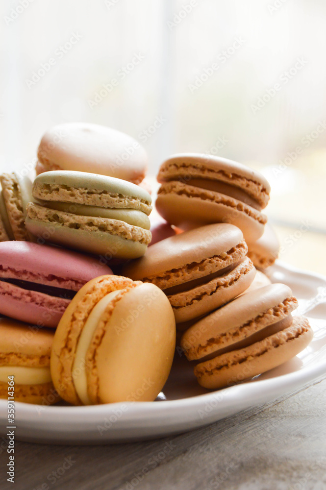 Fototapeta premium Pastel macarons on a white plate