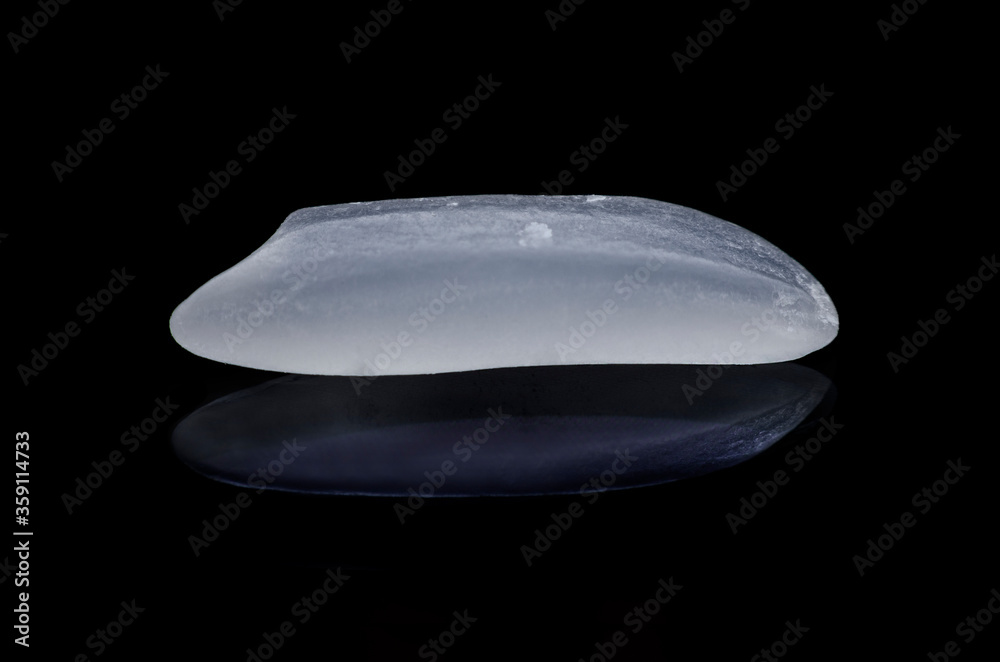 1 grains of uncooked rice, isolated on a black background. Extreme close-up. 1 grains of uncooked rice, isolated on a black background. Extreme close-up.