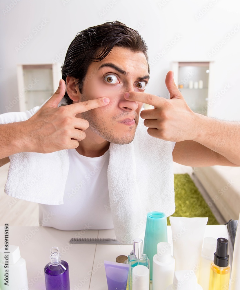Young handsome man in the bathroom in hygiene concept Young handsome man in the bathroom in hygiene concept