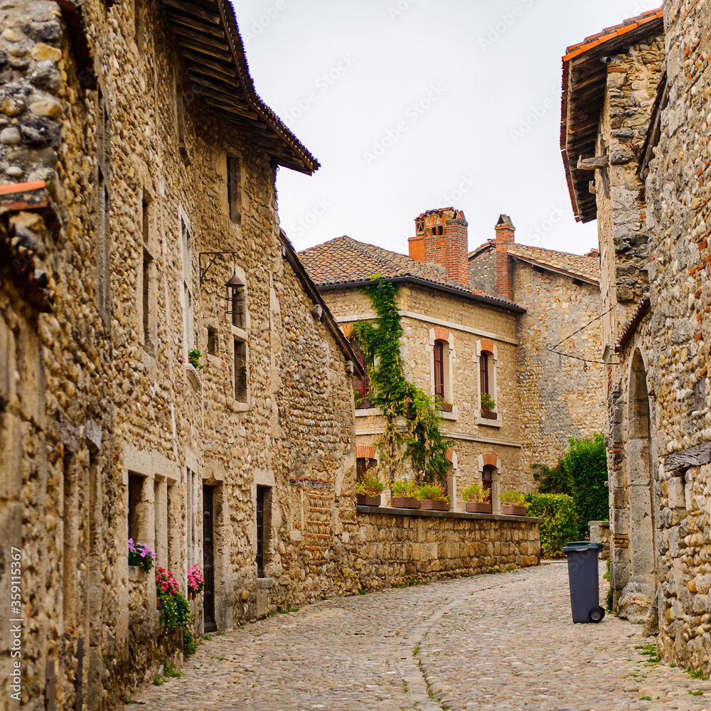 Narrow street in  Perouges, France, a medieval walled town, a popular touristic attraction.