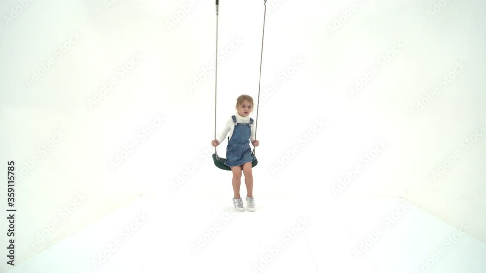 Lovely Blonde Girl Swinging on Rope Swing and Looking at Camera Lovely Blonde Girl Swinging on Rope Swing and Looking at Camera