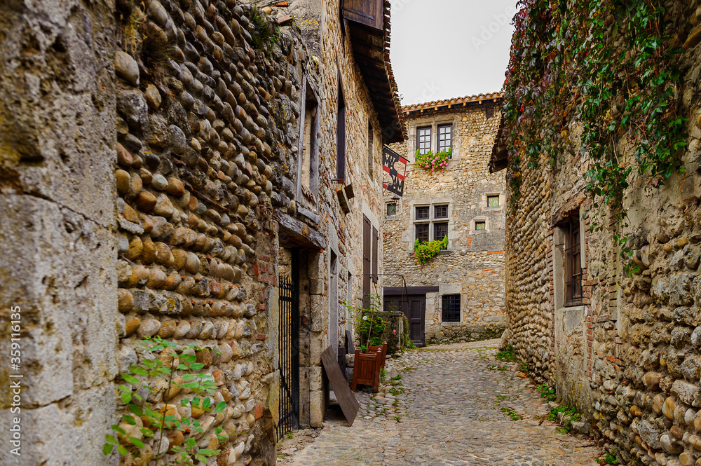 Naklejka premium Narrow street in Perouges, France, a medieval walled town, a popular touristic attraction.