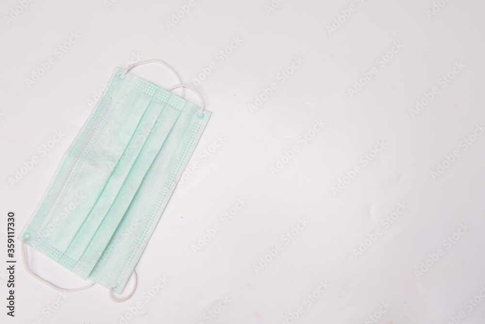 medical syringes and medical face mask,shot from top,spread over white surface medical syringes and medical face mask,shot from top,spread over white surface