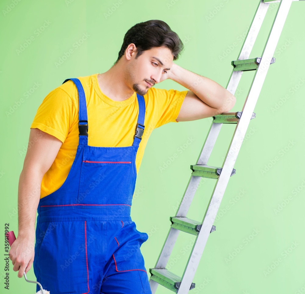 Young painter doing renovation at home Young painter doing renovation at home