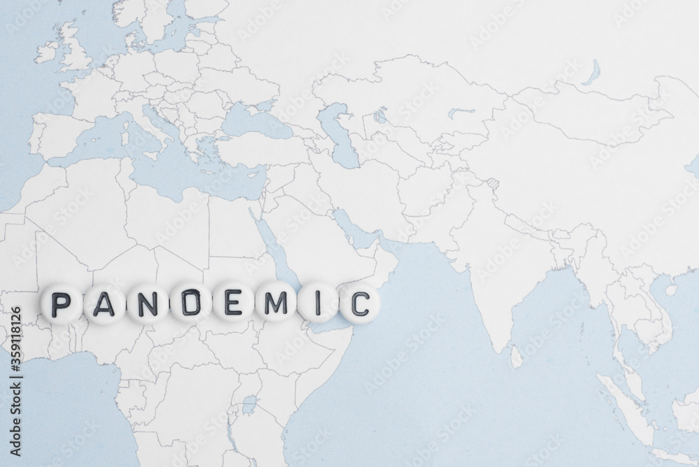 Fototapeta premium The word pandemic over world map