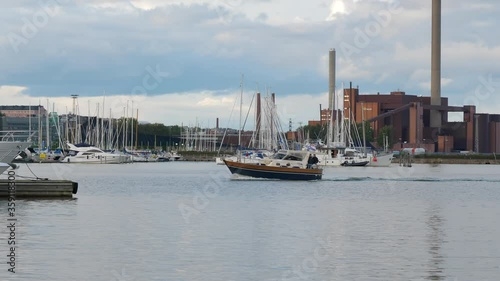 An aprroaching boat on the harbor port in Helsinki Finland photo