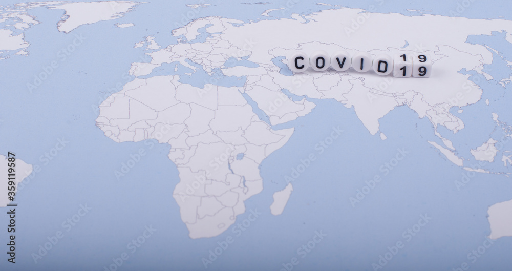 The word covid 19 over world map