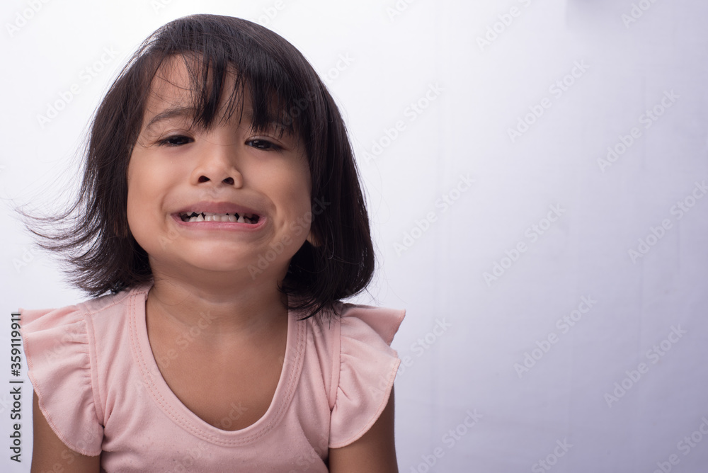 An asian child, with black hair wearing pink dress,showing various expression An asian child, with black hair wearing pink dress,showing various expression