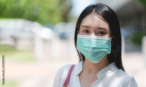 Asian woman wearing surgical mask face protection to avoid the spread coronavirus 