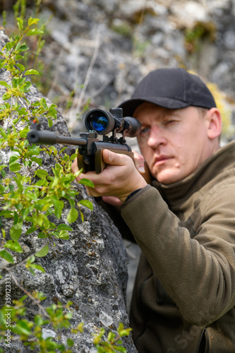 Male with a gun in hunting period