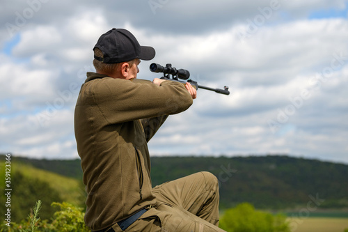 Male with a gun in hunting period