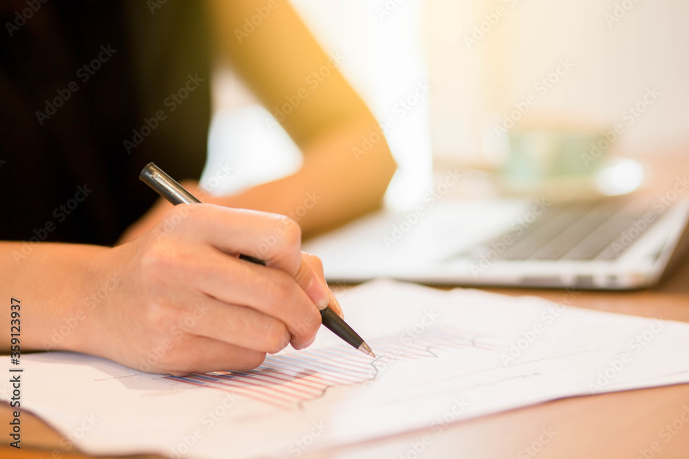 Close up hand of young business women holding pen and working on his plane project at desk work. Close up hand of young business women holding pen and working on his plane project at desk work.