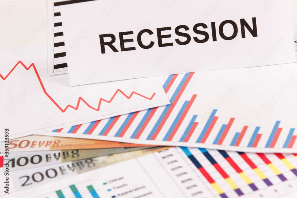 Inscription recession, currencies euro and downward graphs representing financial crisis caused by coronavirus. Global recession. Inscription recession, currencies euro and downward graphs representing financial crisis caused by coronavirus. Global recession.