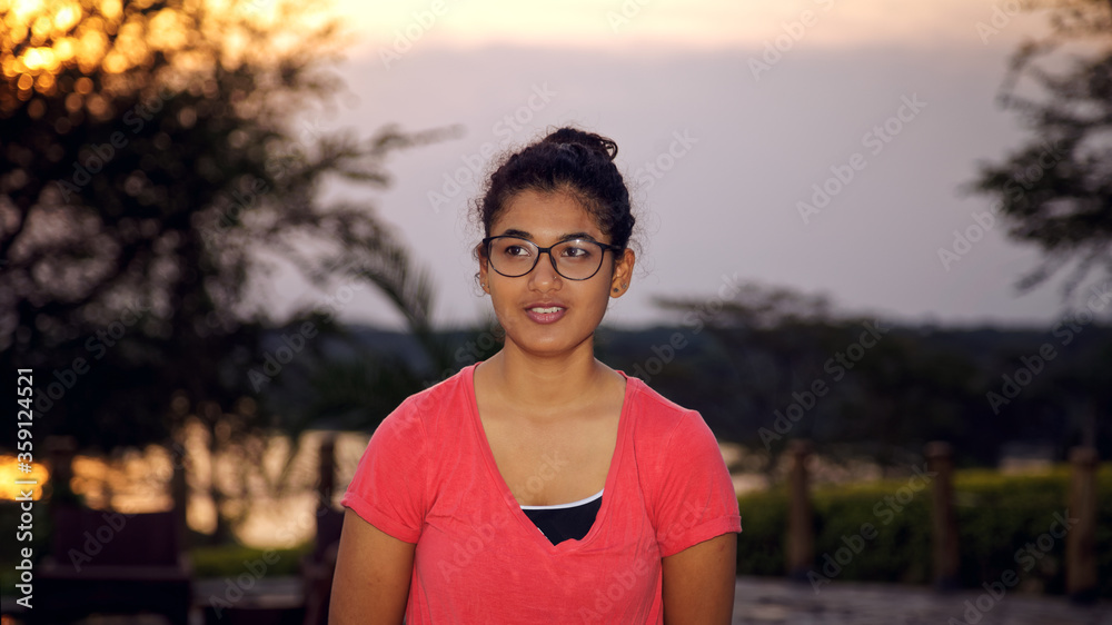 a happy young Asian girl on pool side looking away, amazing sunset in summer. a happy young Asian girl on pool side looking away, amazing sunset in summer.