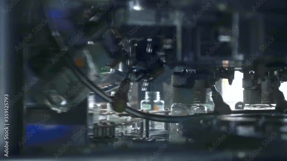 Industrial factory indoors machinery. Robotic factory line for processing and bottling of beverage and juice bottles. Beverage factory interior. Industrial factory indoors machinery. Robotic factory line for processing and bottling of beverage and juice bottles. Beverage factory interior.