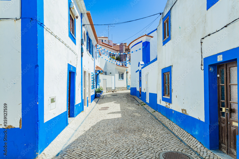 Picturesque streets in the tiny Portuguese ocean village Ericeira, Portugal. Blue streets. Travel to the sea.