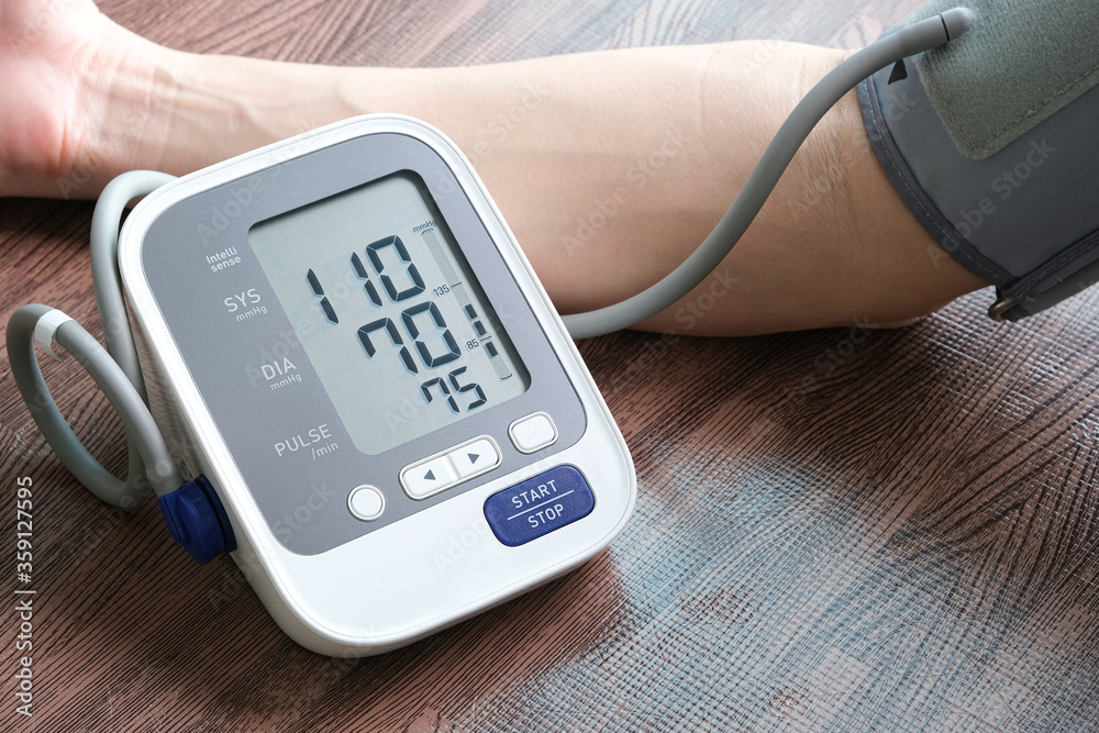 Man check blood pressure monitor and heart rate monitor with digital pressure gauge. Health care and Medical concept Man check blood pressure monitor and heart rate monitor with digital pressure gauge. Health care and Medical concept