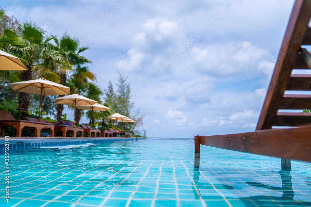 Outdoor swimming pool and Wood bed - chair in the pool with open sky.