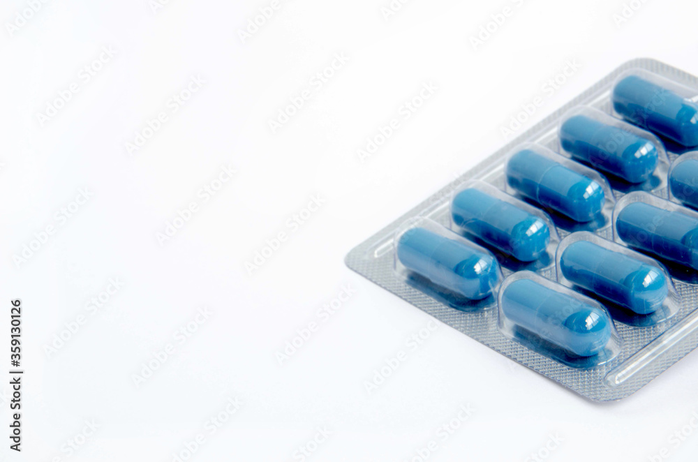 Blister of blue capsules on a white background