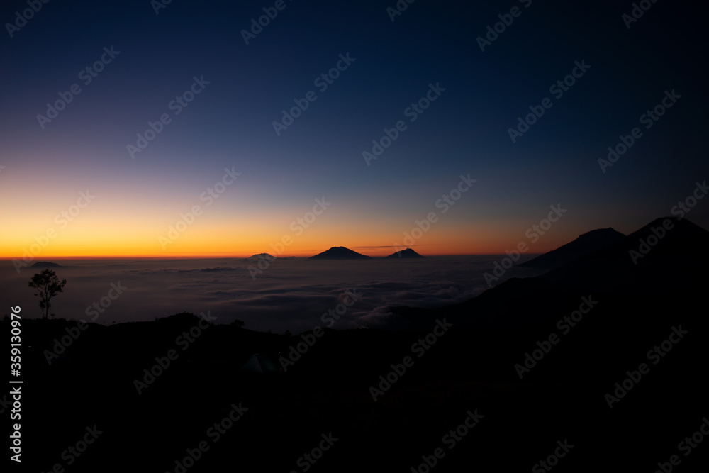 Golden sunrise at Prau mountains. Mt. Prau, Central Java, Indonesia Golden sunrise at Prau mountains. Mt. Prau, Central Java, Indonesia