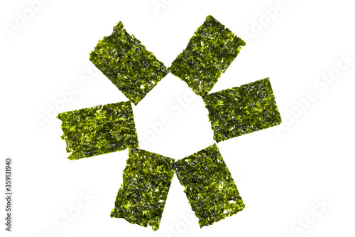 Green seaweed chips, isolated on a white background. Korean healthy snack, healthy food. Close-up view.
