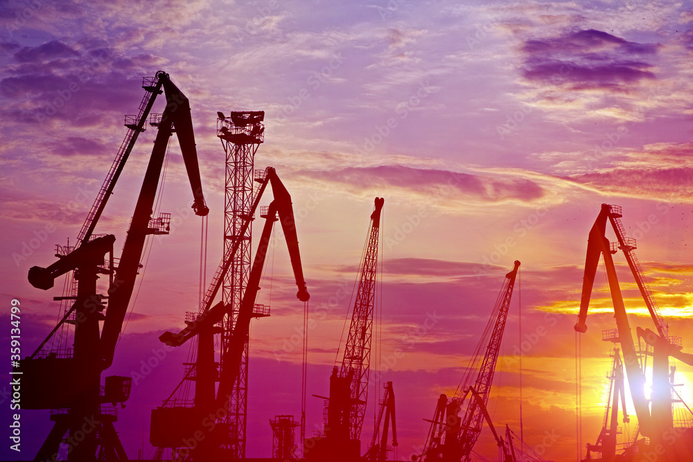 Monumental Cranes at sunset in Sea Port. Outdoors