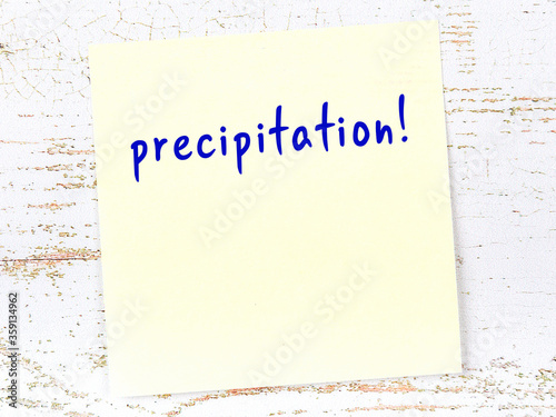 Yellow sheet of paper with word precipitation. Reminder concept