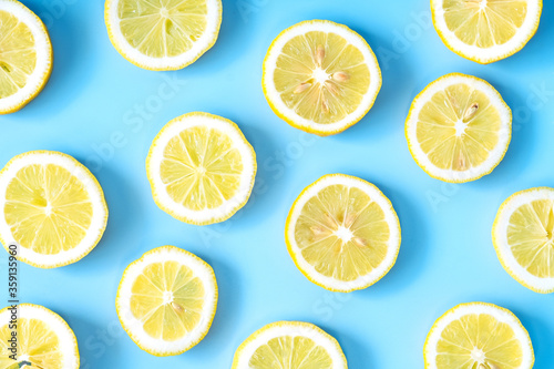 Collection of fresh yellow lemons slice isolated on blue background.