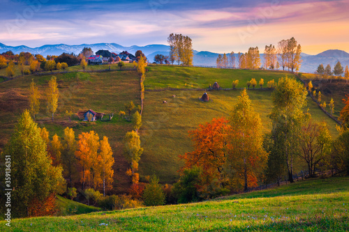 Majestic autumn countryside scenery with houses on the hills, Romania