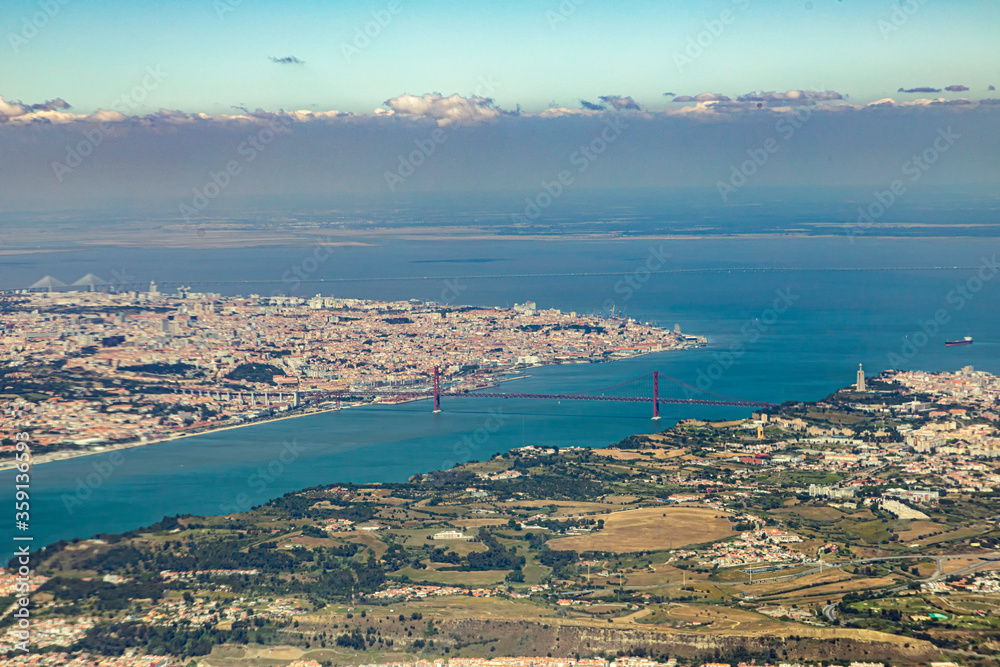 aerial of Lisbon with ocean and famous bridge over river Tejo