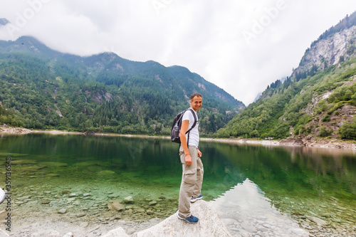 alpine high mountain lake, coniferous woods are reflected in the water, Antrona valley Campliccioli lake, Italy Piedmont