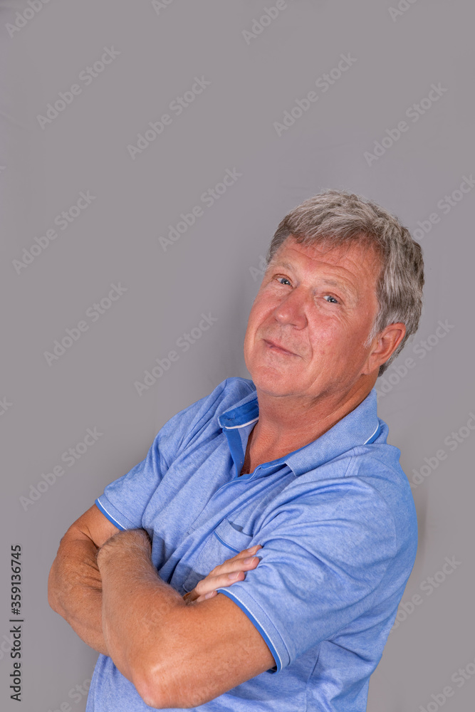 portrait of sixty year old attractive senior man in blue shirt portrait of sixty year old attractive senior man in blue shirt