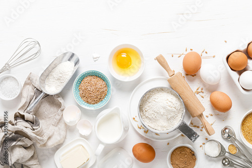 Fotografi Baking homemade bread on white kitchen worktop with ingredients for cooking, cul
